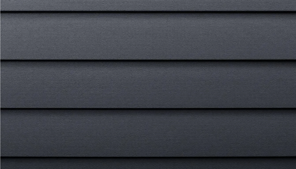 Dark Gray Siding - Ranch Style Homes USA A close-up view of dark gray siding showcases the textured paint and contrasting white window trim, highlighting the architectural details of the home's exterior. This detail emphasizes the classic look and curb appeal of the ranch house, adding warmth and visual interest to the facade.