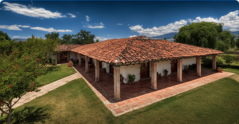 The image depicts a stunning Mexican ranch house characterized by its classic red tiled roofs and high ceilings that allow natural light to fill the spacious interior. Surrounded by lush gardens and open spaces, this stylish home blends rustic charm with modern comforts, creating an idyllic setting for relaxation and outdoor gatherings.