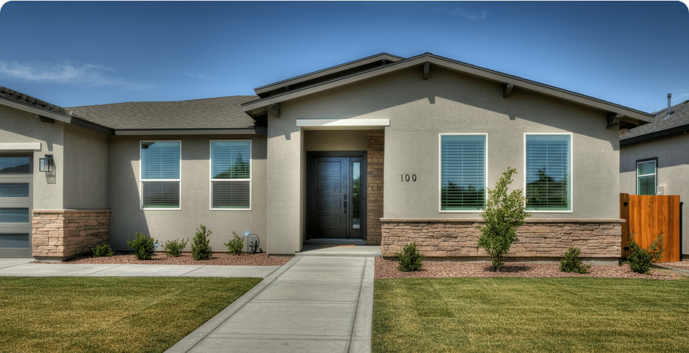The image depicts a modern ranch style home with a stucco exterior, showcasing a welcoming front door and large windows that allow natural light to flood the interior. The elegantly designed facade reflects careful planning, demonstrating how homeowners can create a stylish yet budget-friendly property.