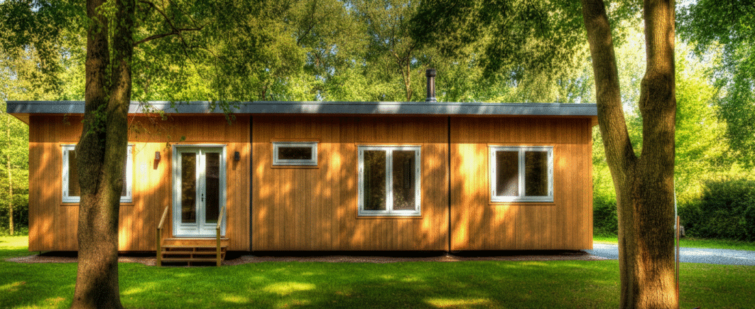 Photograph of a modern, minimalist wooden cabin nestled in a lush green forest, bathed in warm sunlight, evoking tranquility and sustainable living.